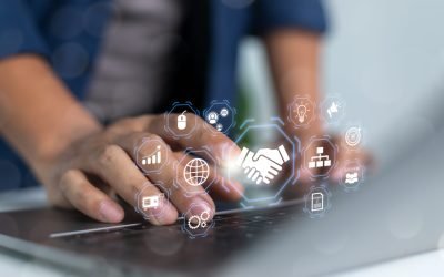 Business professional using a laptop with digital partnership interface, handshake icon, online collaboration, networking, workflow management, and global communication technology concept.